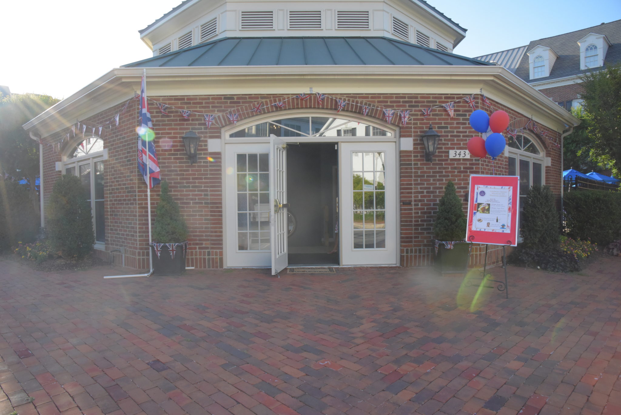the front door of the Old Town Village in Alexandria pool house decorated with red and blue balloons 