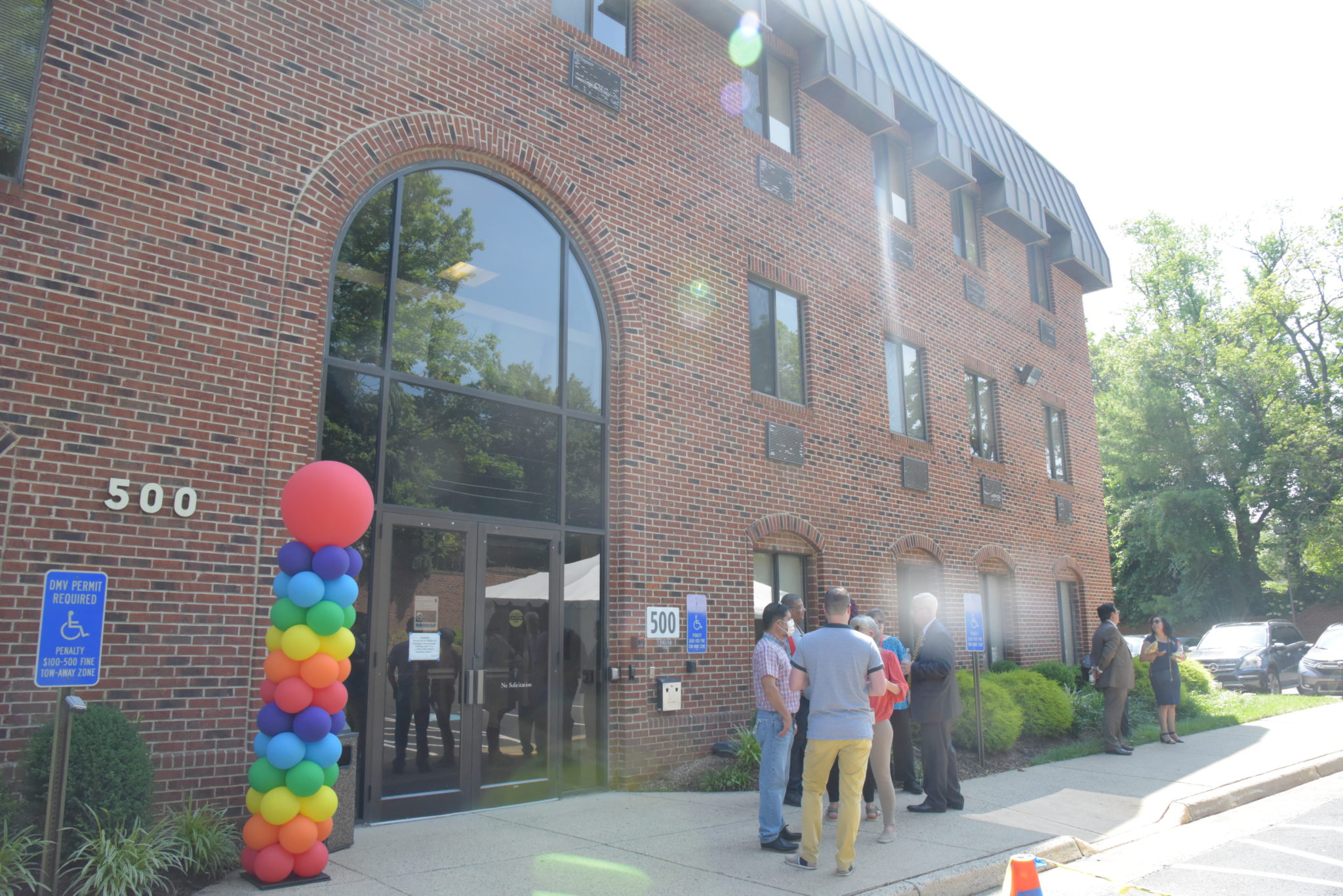 the front of the Inova Pride Clinic at 500 Washington St in Falls Church surrounded by rainbow balloons