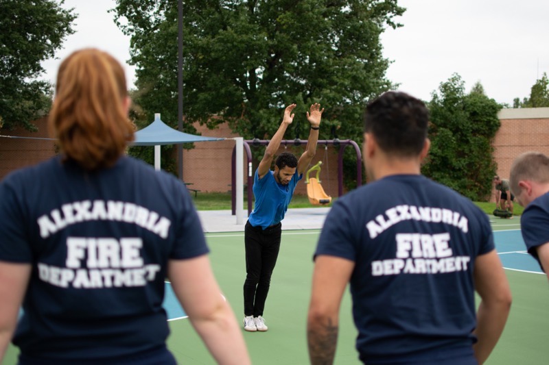 an alexandria fire department member looks on as recruits train in o2x program 2022