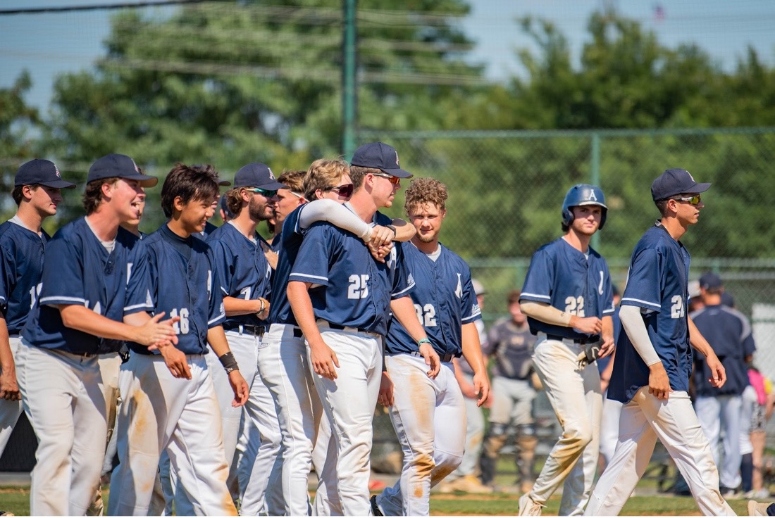 the alexandria aces baseball team groups together to celebrate a win