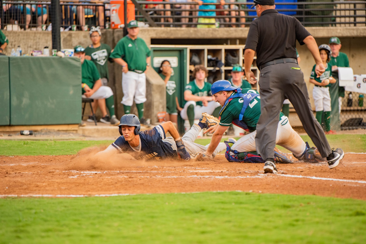 aces player slides into home securing first run