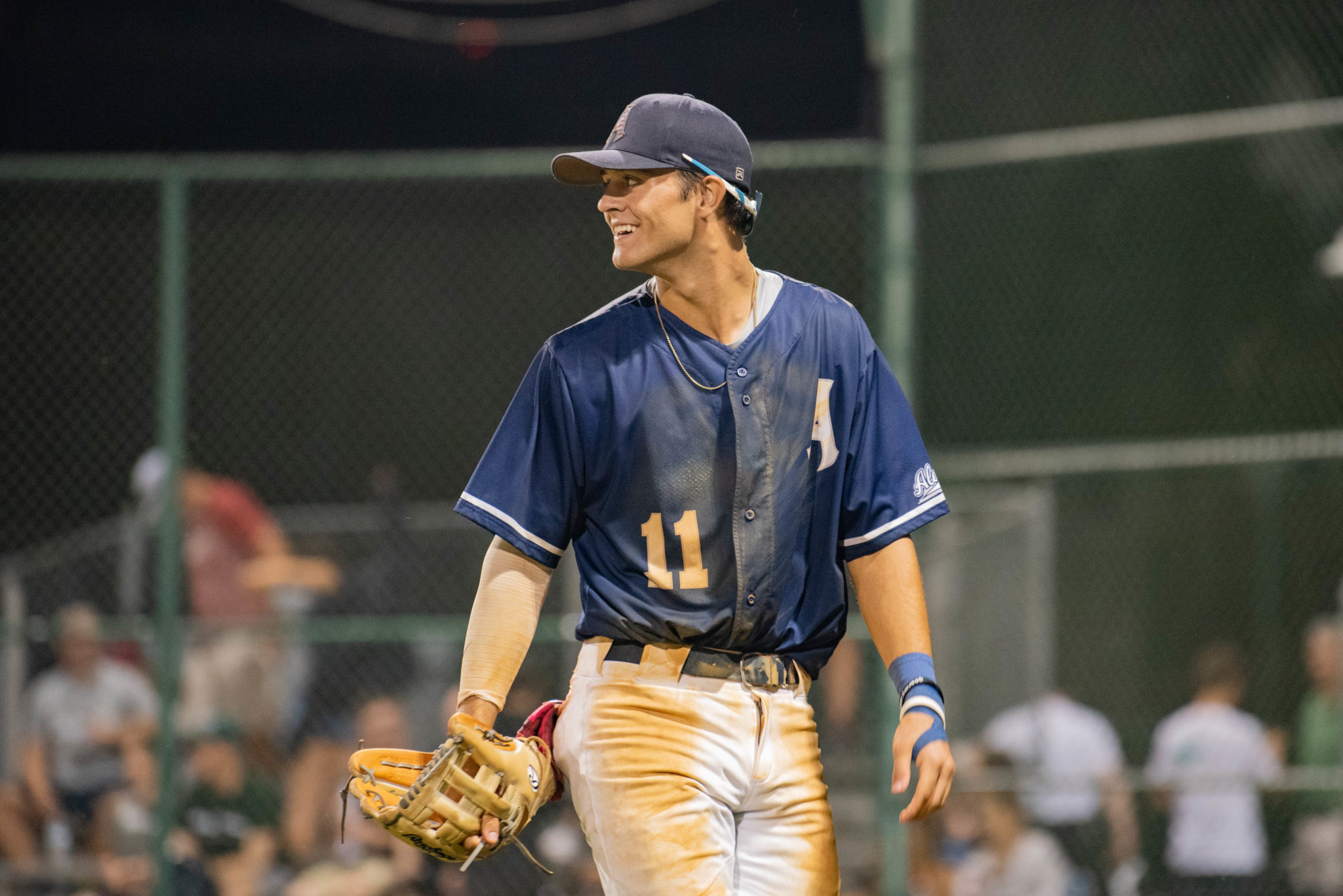 aces player smiling on field looks over his right shoulder