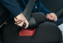 a child buckles a passenger safety seat