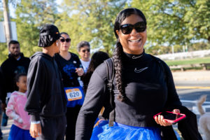 woman with braid and sunglasses walking