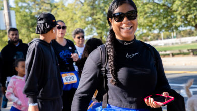 woman with braid and sunglasses walking