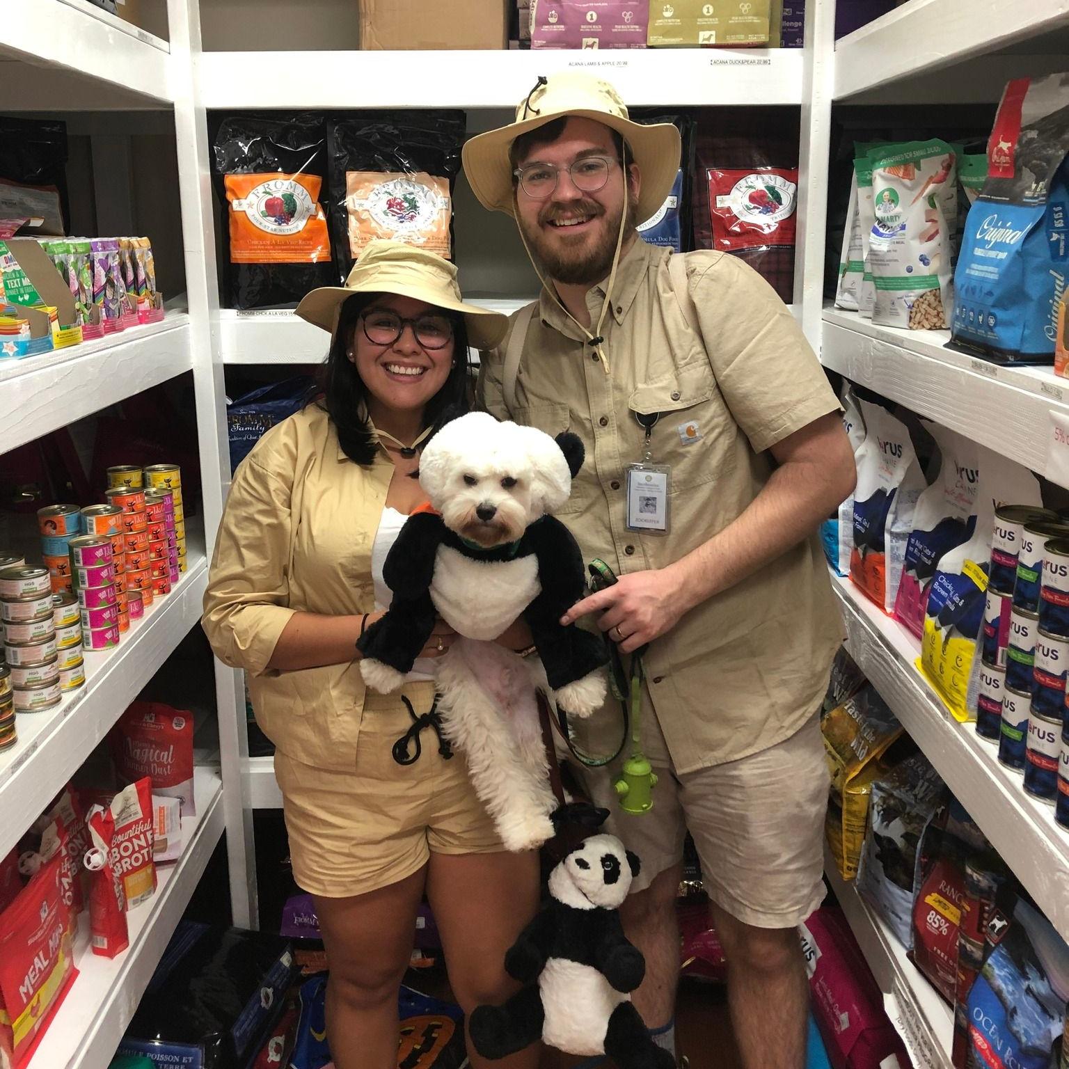 a man and woman with dog, all dressed in safari costumes