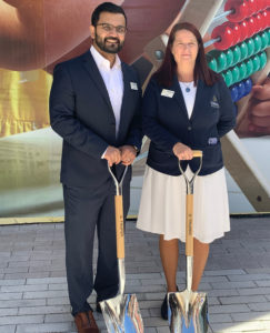 man and woman holding shovels