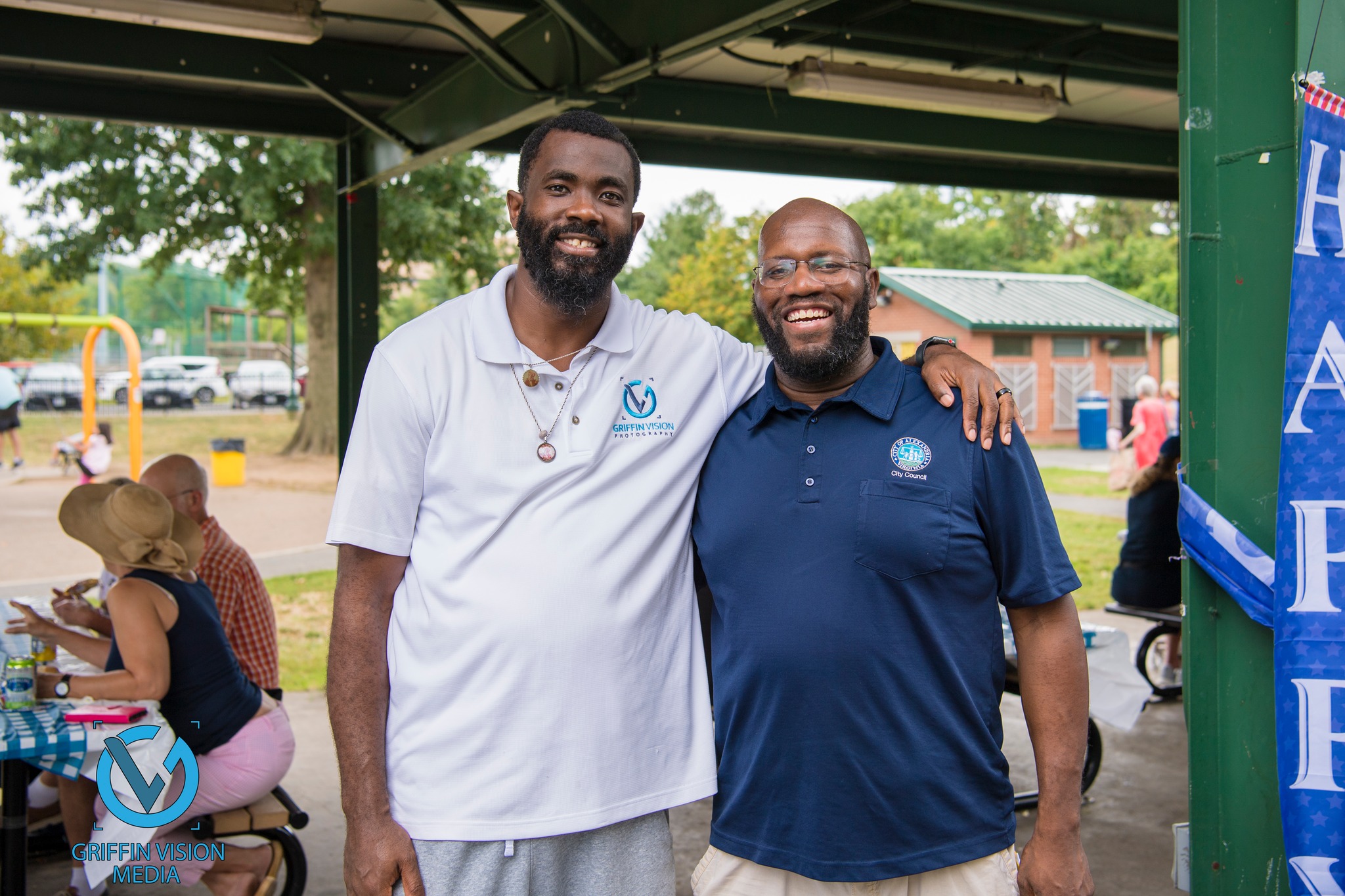 two african american men stand side by side at outdoor park