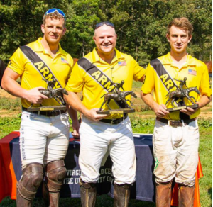 Three polo players pose in uniform