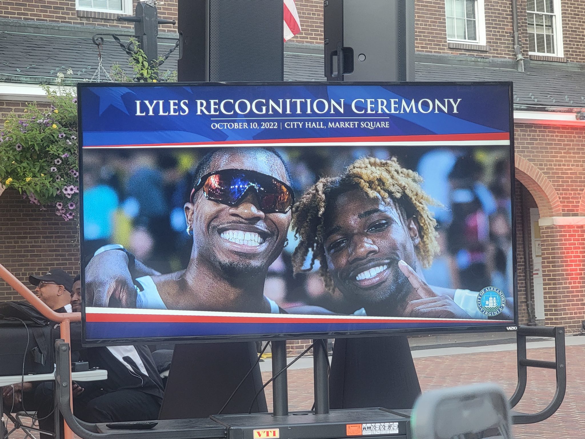 A screen image of the Lyles Brothers olympic track and field athletes that reads Lyles Recognition Ceremony