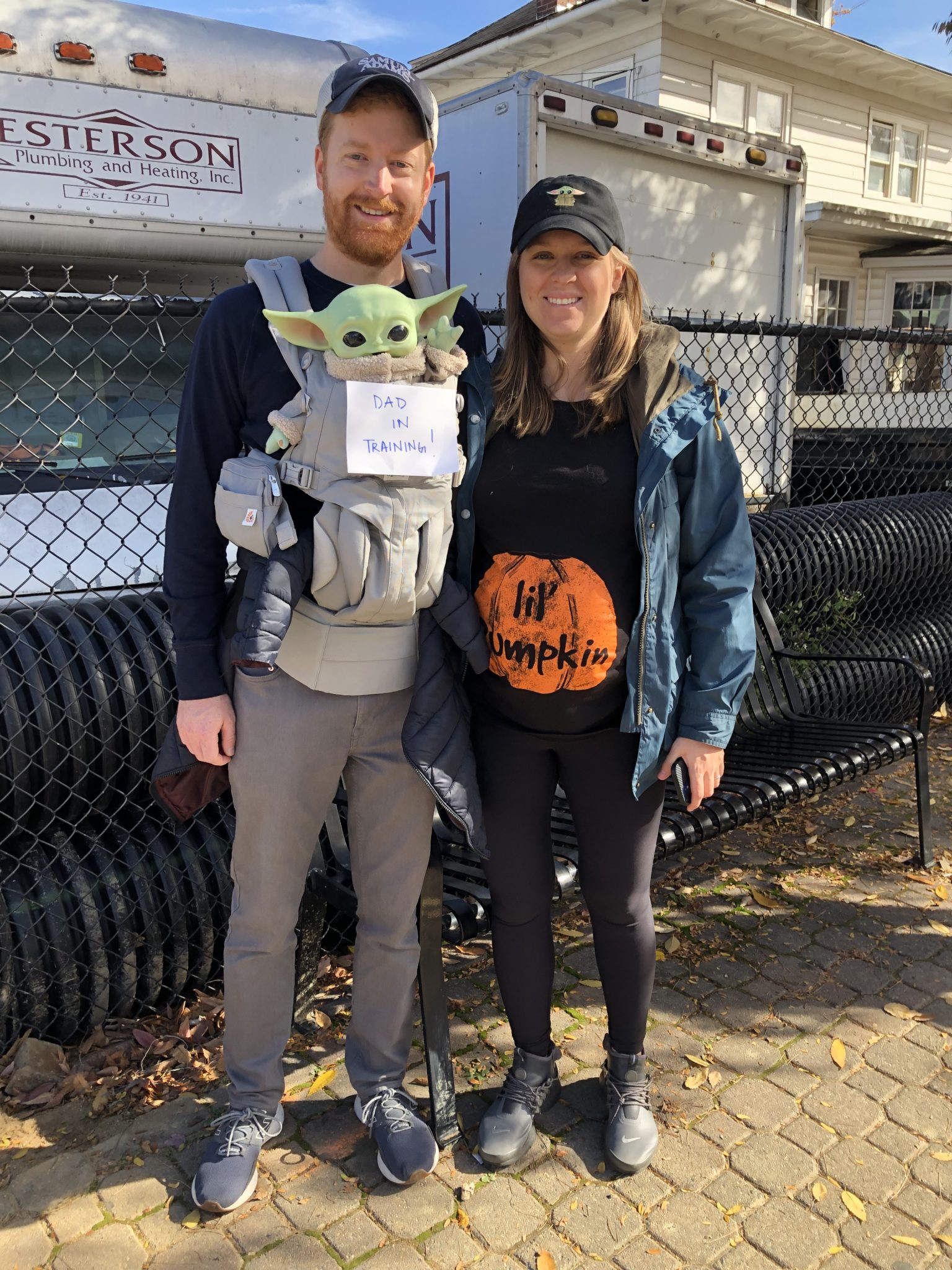 a mom and dad holding a baby yoda