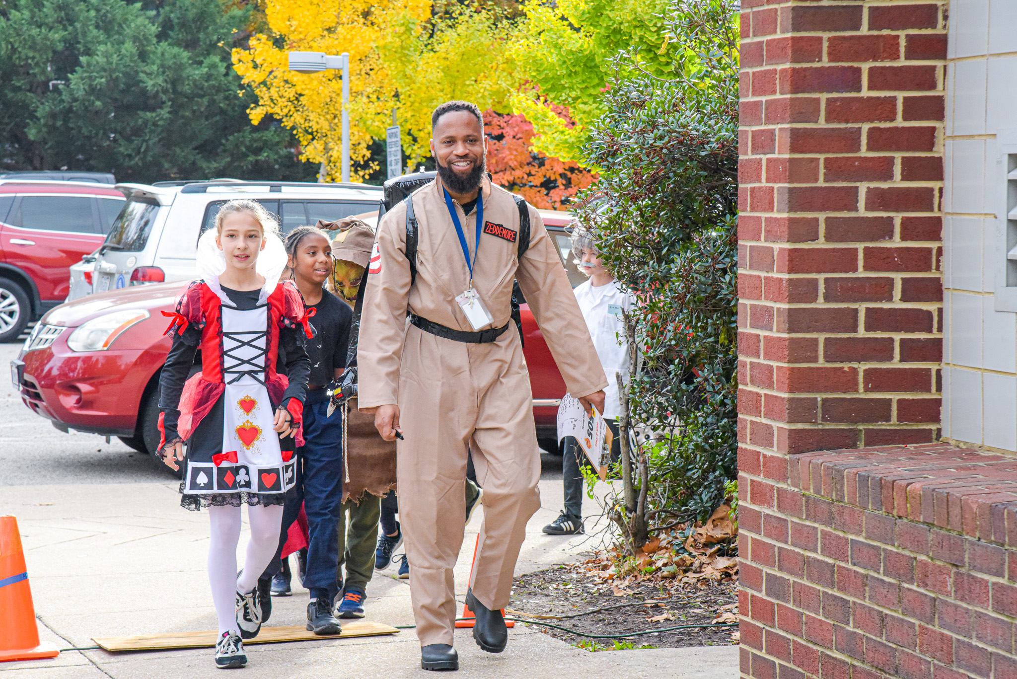 a male teacher walks with female student, both in halloween costumes