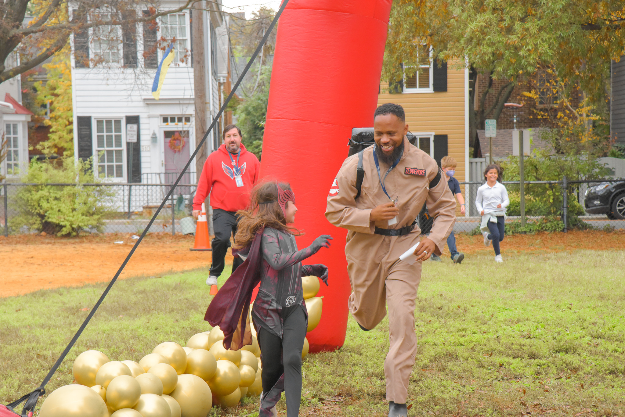 A Lyles Crouch teacher and student run outdoors in halloween costumes