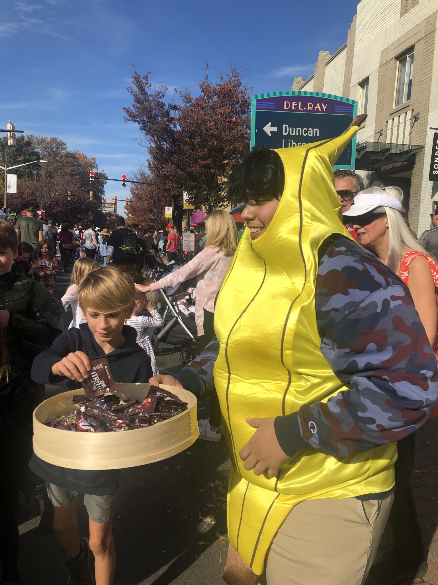 a teenage boy dressed as a banana handing out candy at halloween