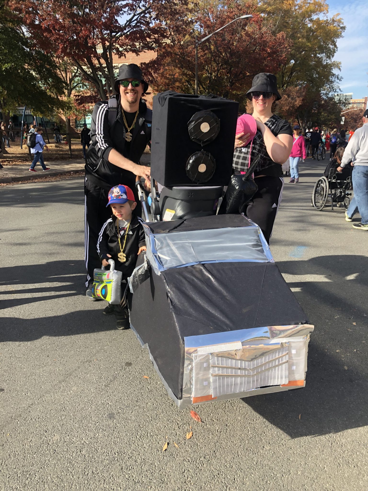 a family dressed as rappers with a boombox