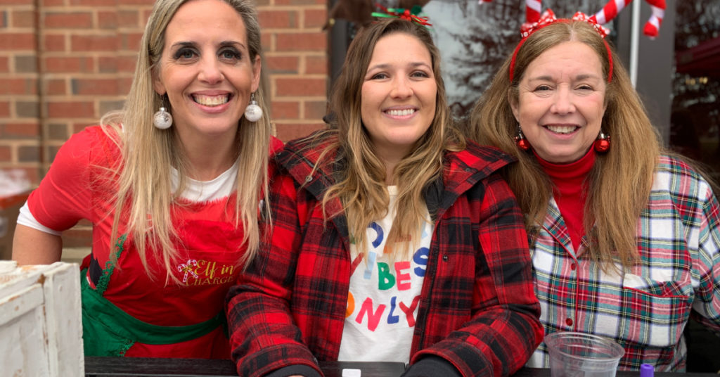 three ladies at Lena's check-in table