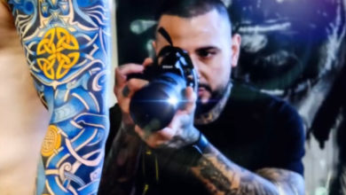 tattoo artist taking photo of arm tattoo