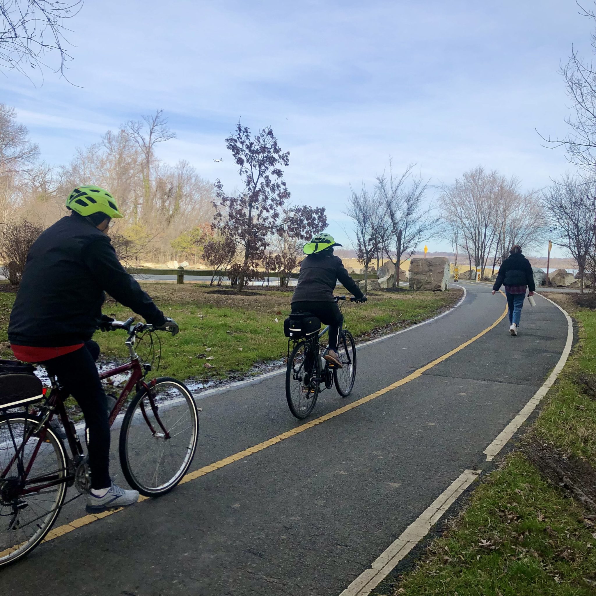 bike riders and lady walking