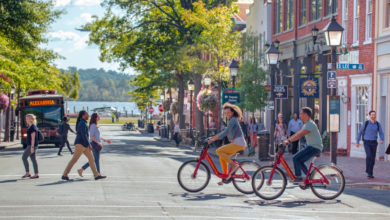 People walking and biking in the 100 block on King Street in Alexandria, Virginia. (Photo: visit Alexandria)