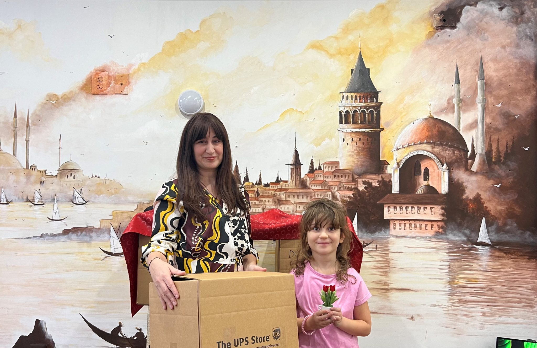 Gizem Salcigil White at The Turkish Coffee Lady Mural with Donation box for Earthquake Victims. (Photo: The Turkish Coffee Lady)