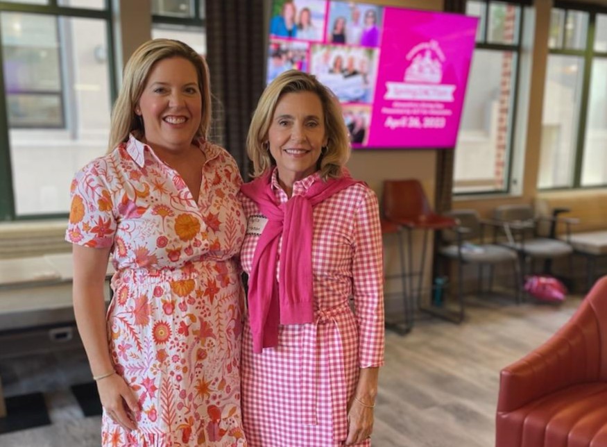 Two ladies in pink dresses.