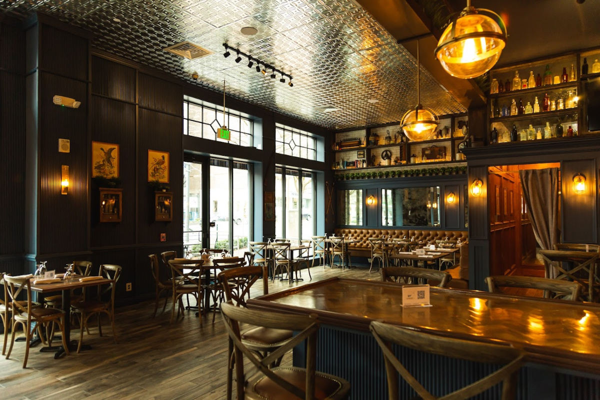Elegant wood-paneled bar and restaurant with low lighting.