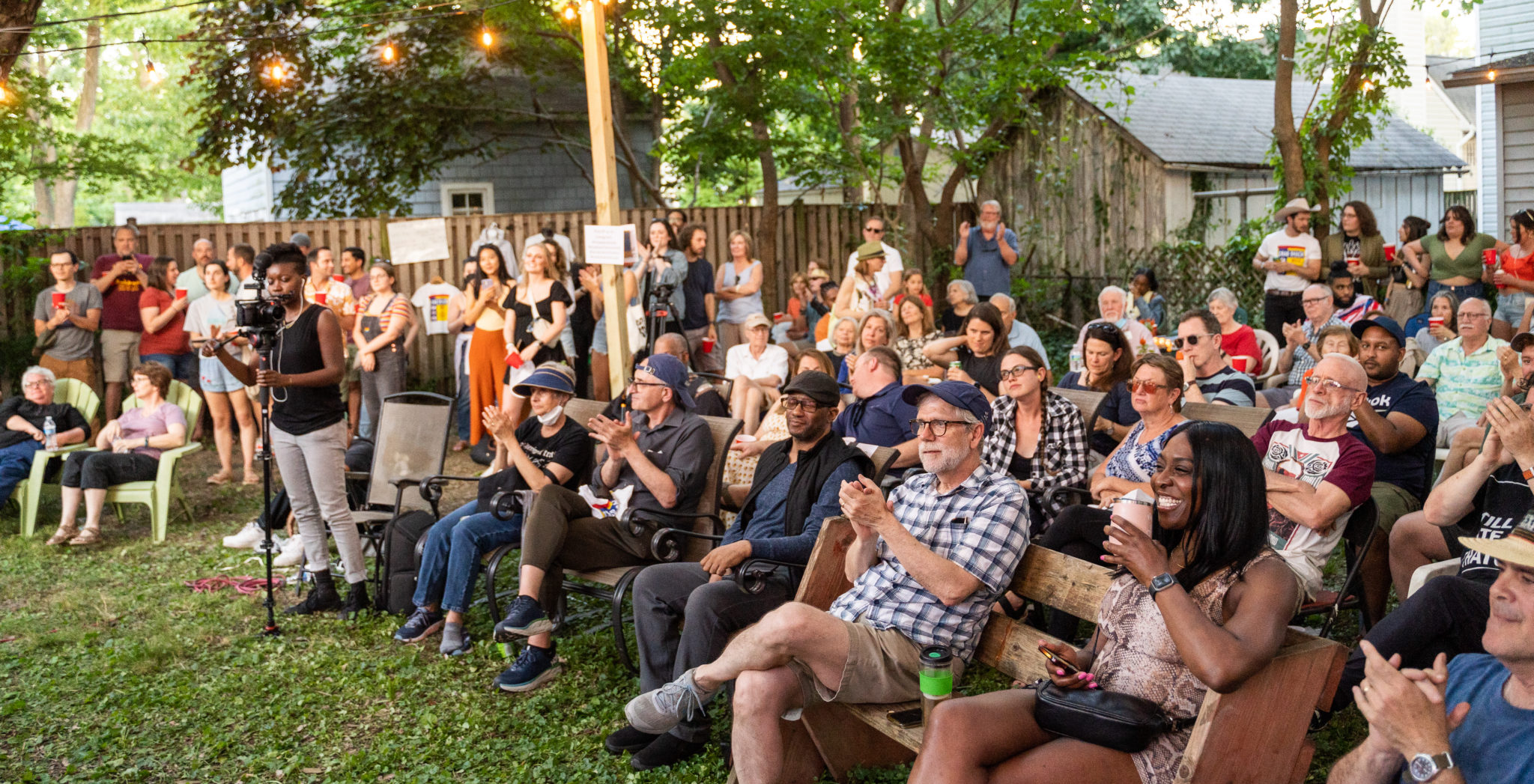 crowd in a backyard listening to music