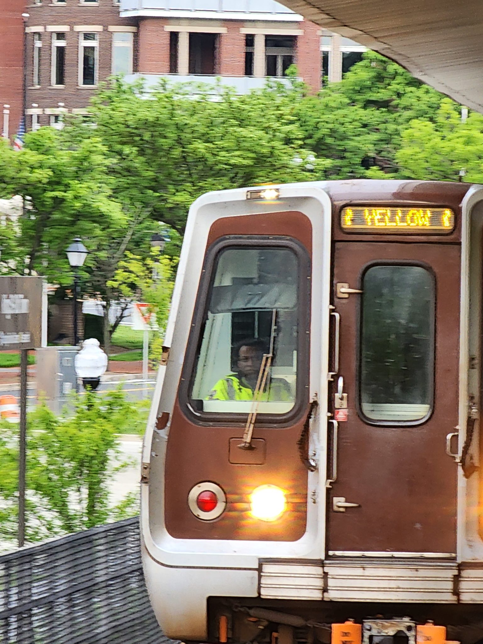 Metro car on tracks that says Yellow on front.