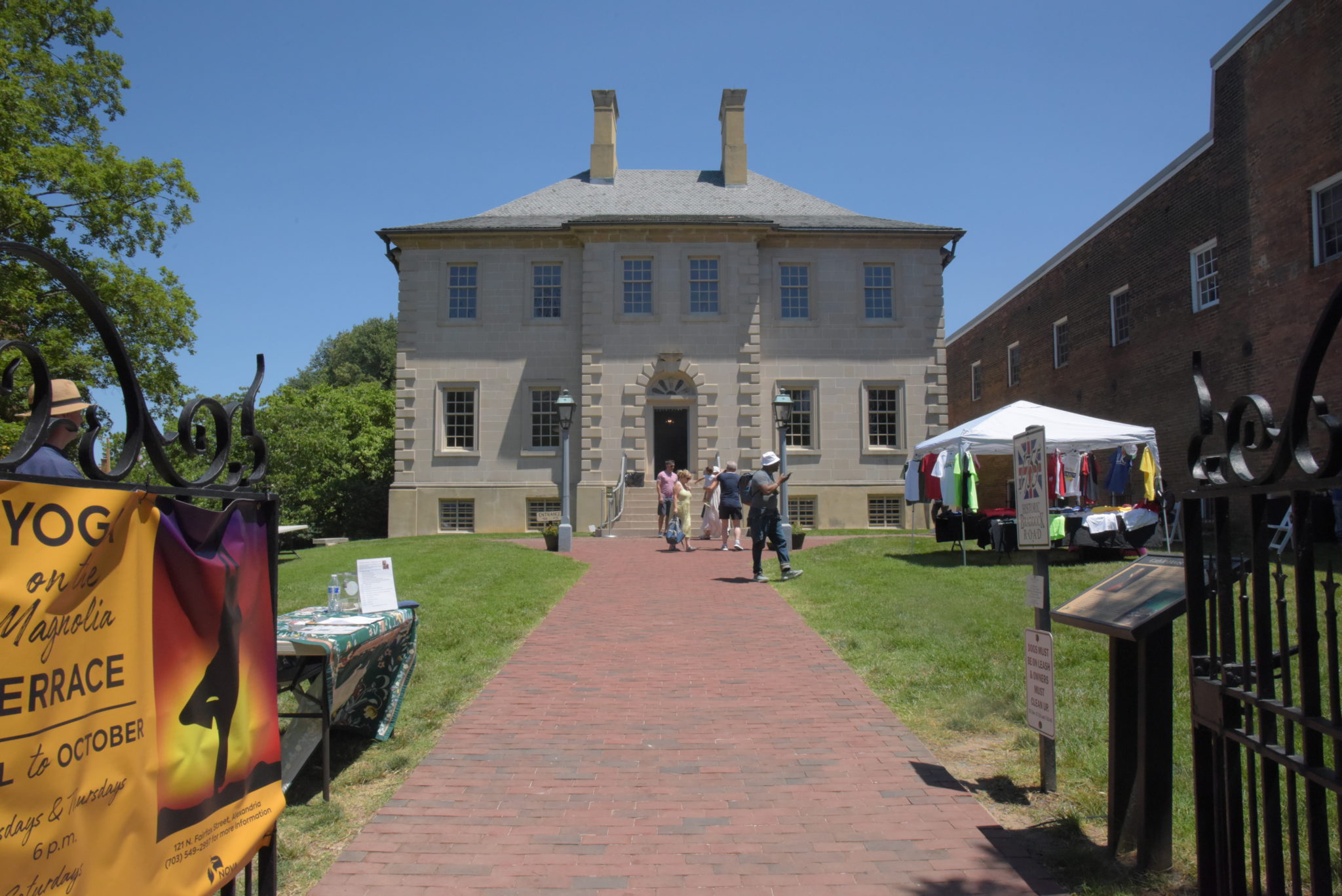 Stone four-square 18th century house with brick walkway 