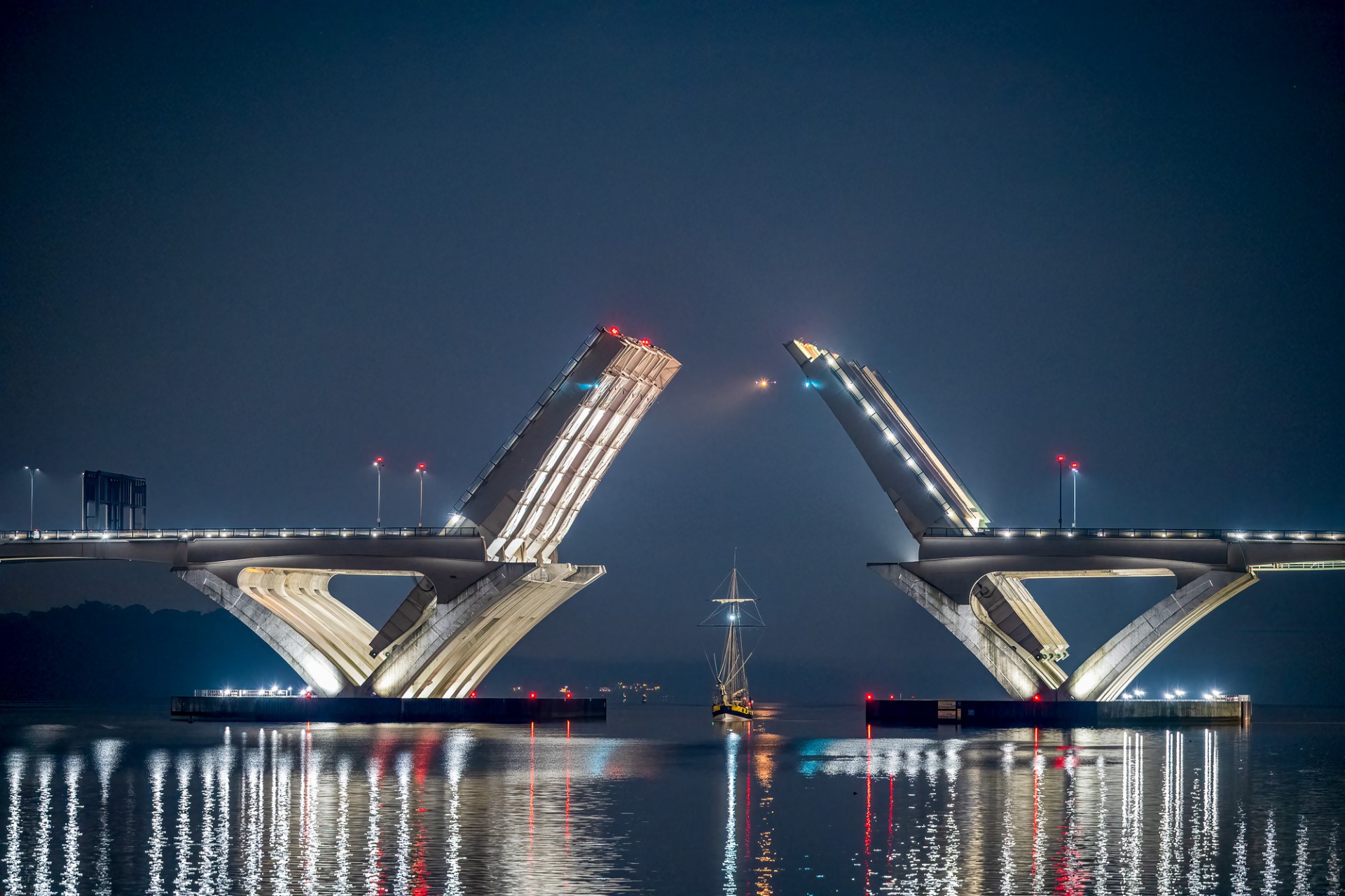 18th century tall ship sails in moonlight under the opened Woodrow Wilson Draw Bridge in the Washington DC area. (Photo: Daniel Horowitz)