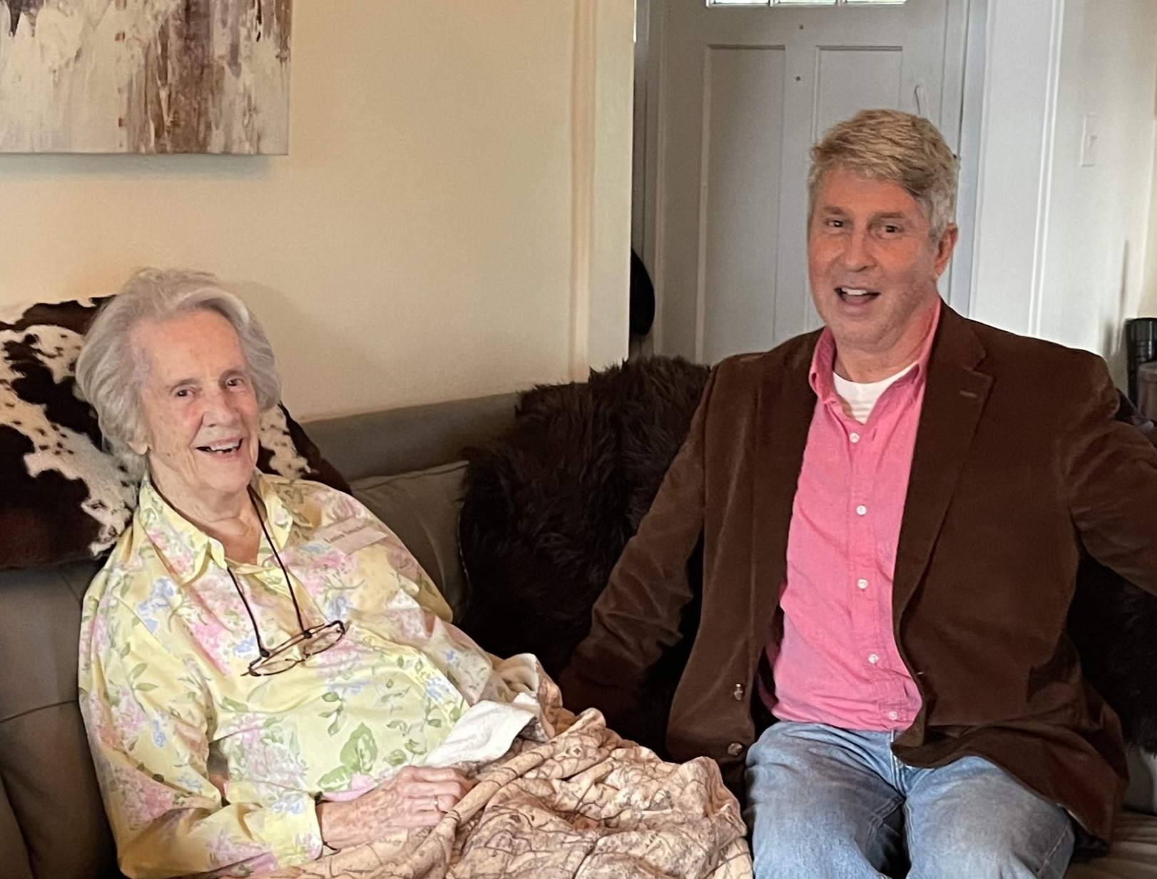 Older woman and man on sofa.