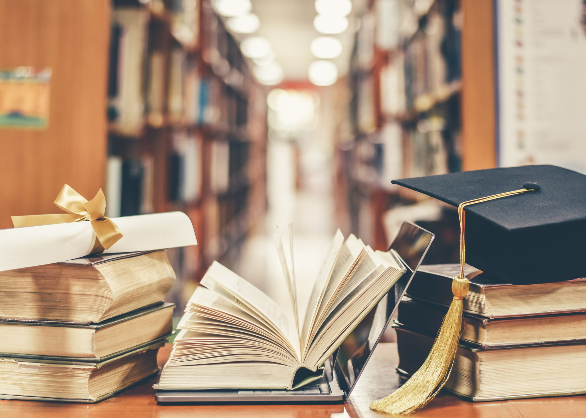 E-learning class and internet online education success with IT c Open book with library behind.