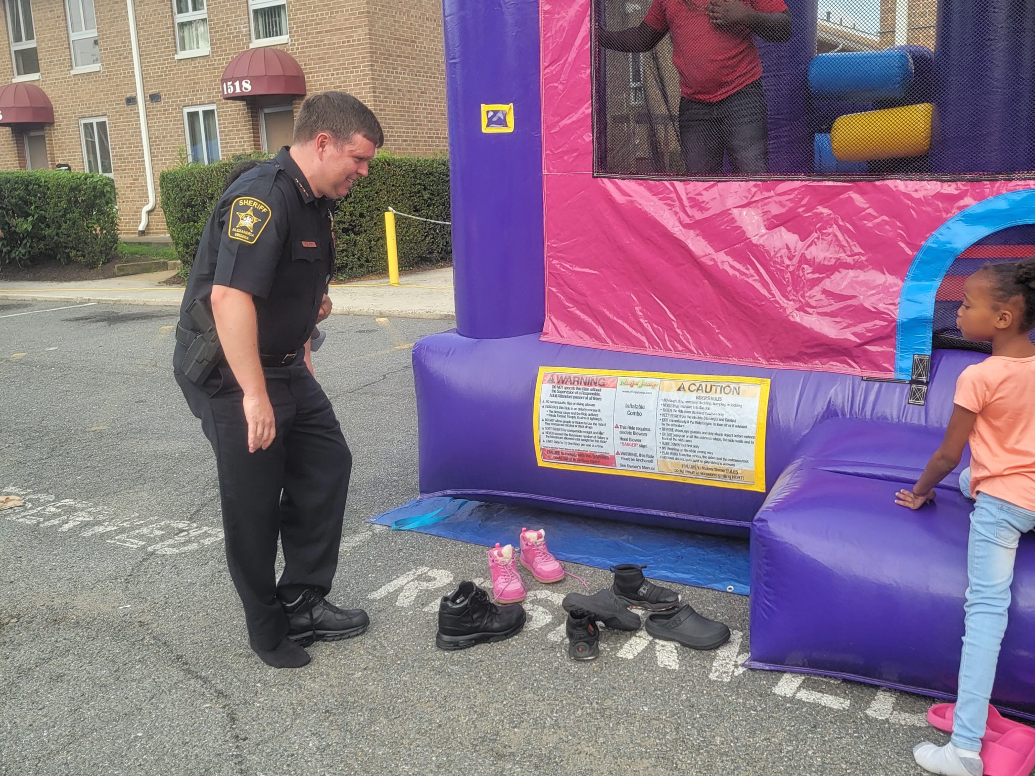 Alexandria Sheriff Sean Casey, removing his shoes, preparing to crawl into the slide (Photo Lucelle O’Flaherty)