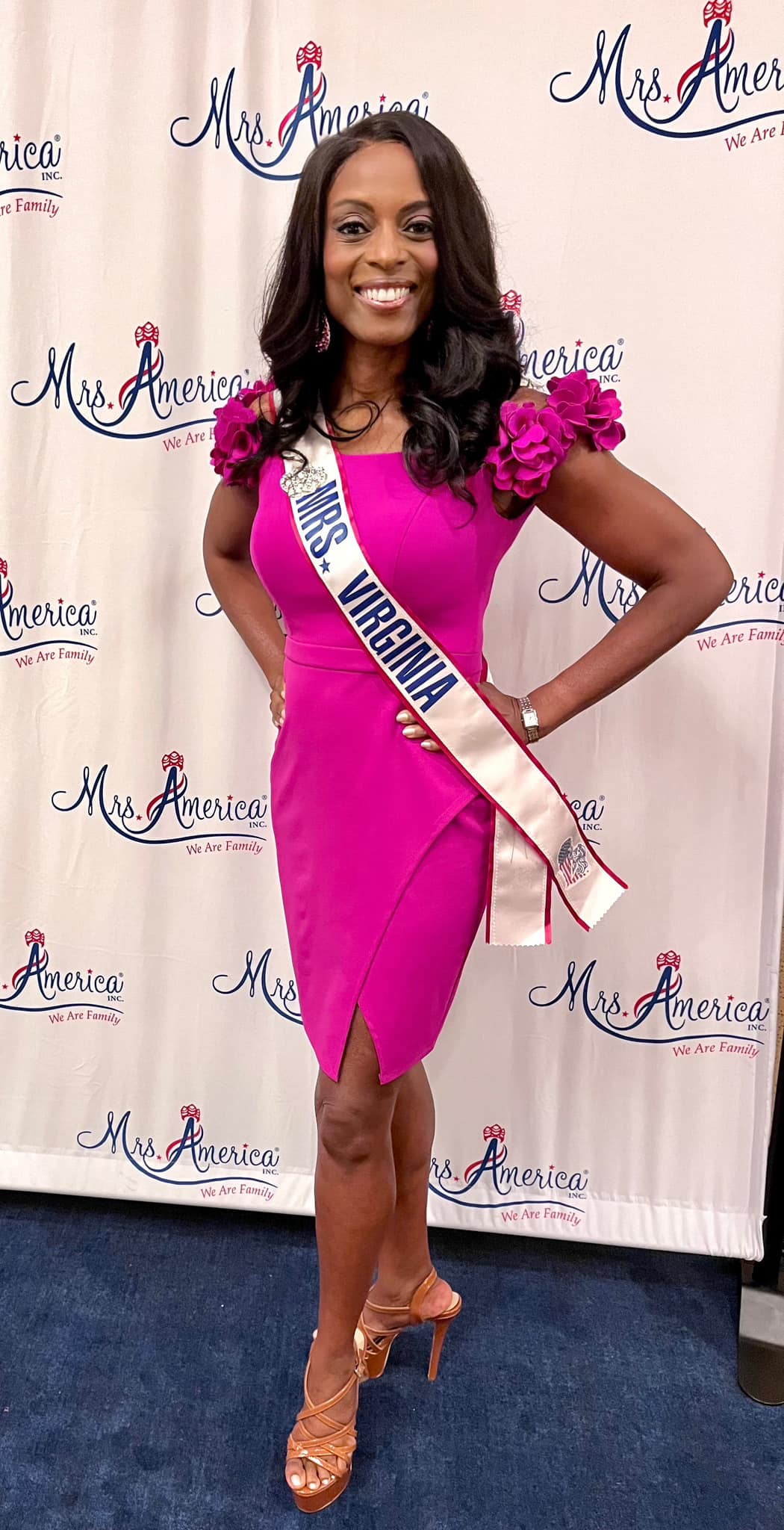 Black lady in pink dress with sash that says Mrs. Virginia.