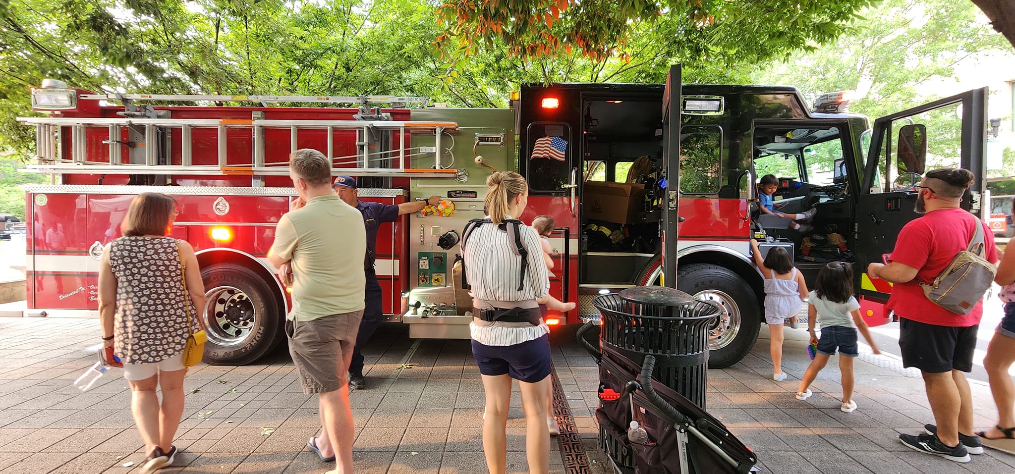 Onlookers gather to talk to fire department personnel at John Carlyle Square (Photo Judith Fogel)