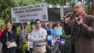 Coalition for a Livable Alexandria Chairman Roy Byrd. Looking on is Will Shen, Coalition treasurer. Holding sign is owner of Del Ray Café Laurentis Janowsky. Left corner is former Alexandria Mayor Allison Silberberg. Rear center under sign is Erin Winograd (Photo Lucelle O’Flaherty)   