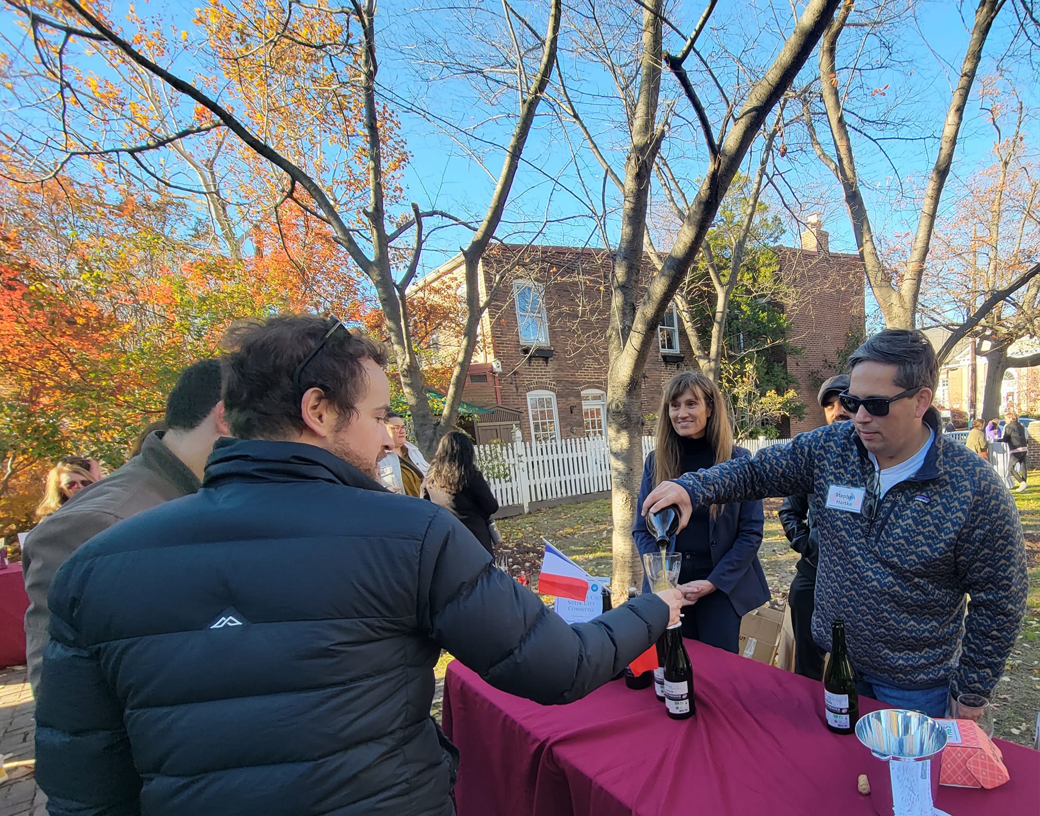 Man pours cider into a guest's glass at cider festival in Alexandria, Virginia.