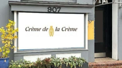 Gray Storefront that says Creme de la Creme and has the number 907 above the logo.