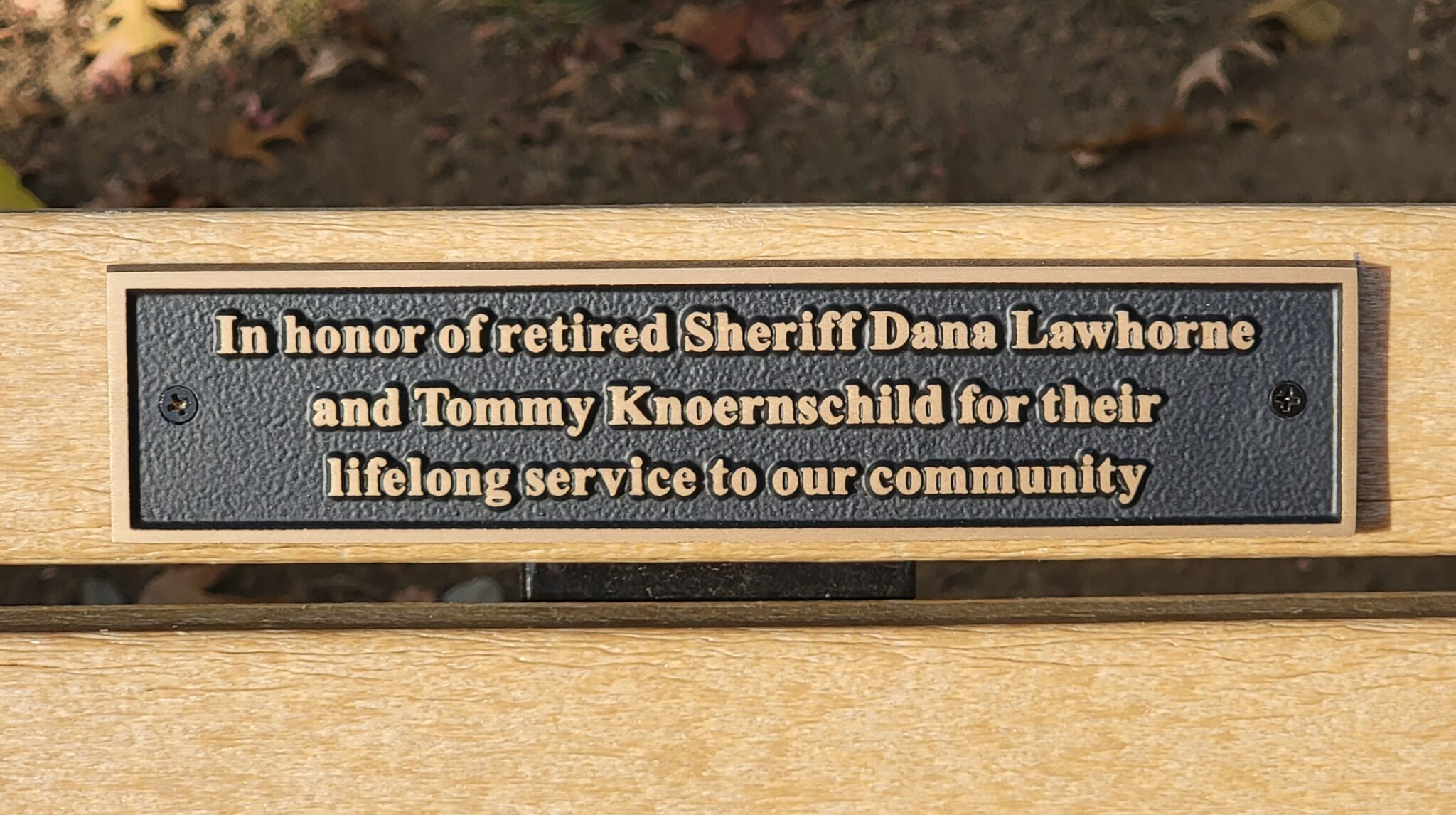 Inscription on bench close up.