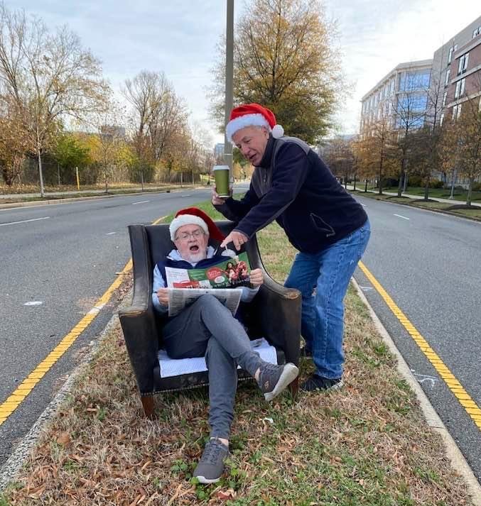 John Porter (seated) and Dana Lawhorne cut up in the Commonwealth Avenue median where a chair was abandoned. (Courtesy photo)