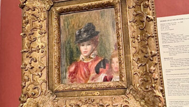 Golf framed Renoir painting of a woman in a hat.