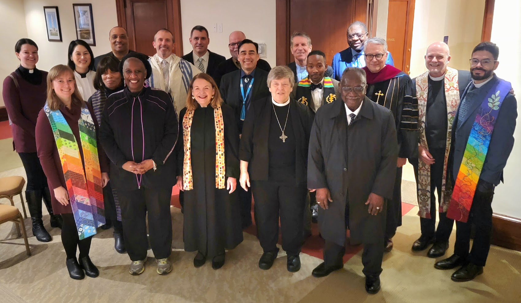 Two rows of clerical people dressed according to their religion.