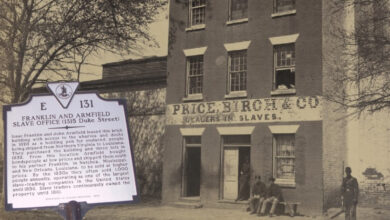 Old black and white photo of the original building where the slaves were housed before auctions