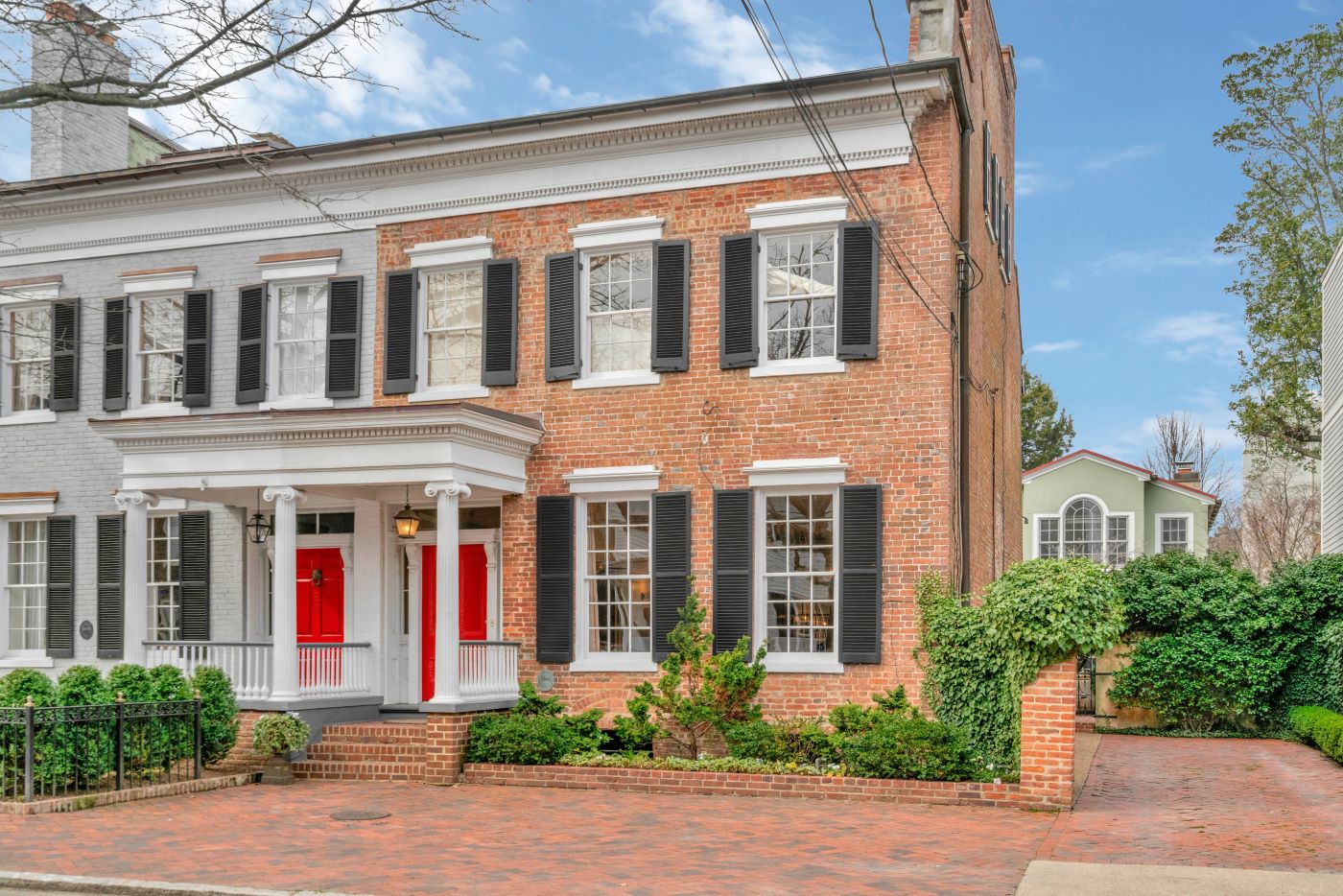 Exterior photo of large brick end unit townhouse.