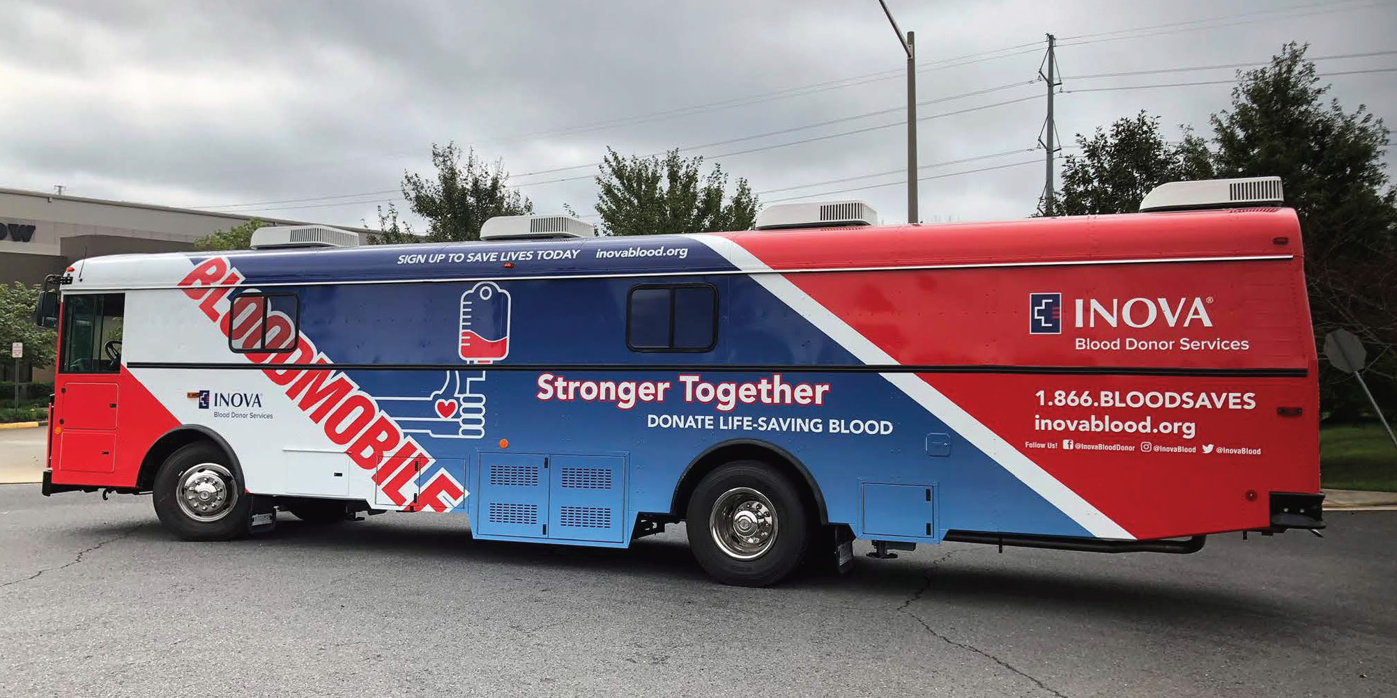 big bus decorated red white and blue that says INOVA Bloodmobile