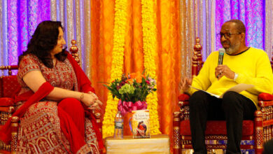 Monica Saigal seated on a stage being interviewed by Koho Nnamdi.