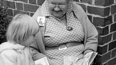 Older lady reading book to child