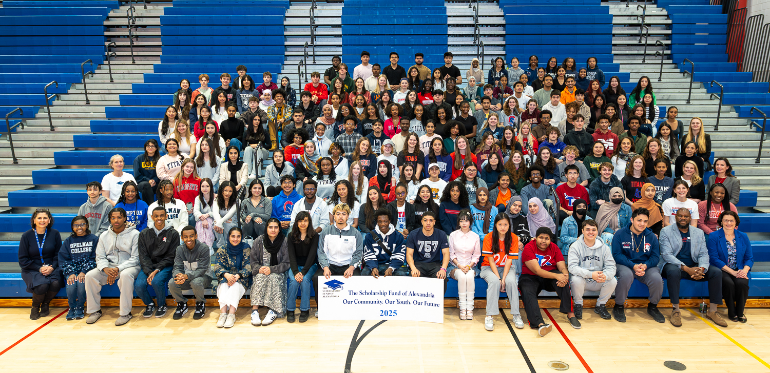 2025 SFA Recipients Large group of students facing camera behind a sign that says Scholarship Fund of Alexandria