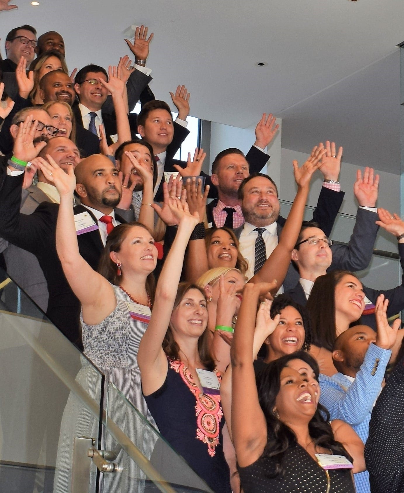 40 under 40 2016 A group of people on a staircase waving