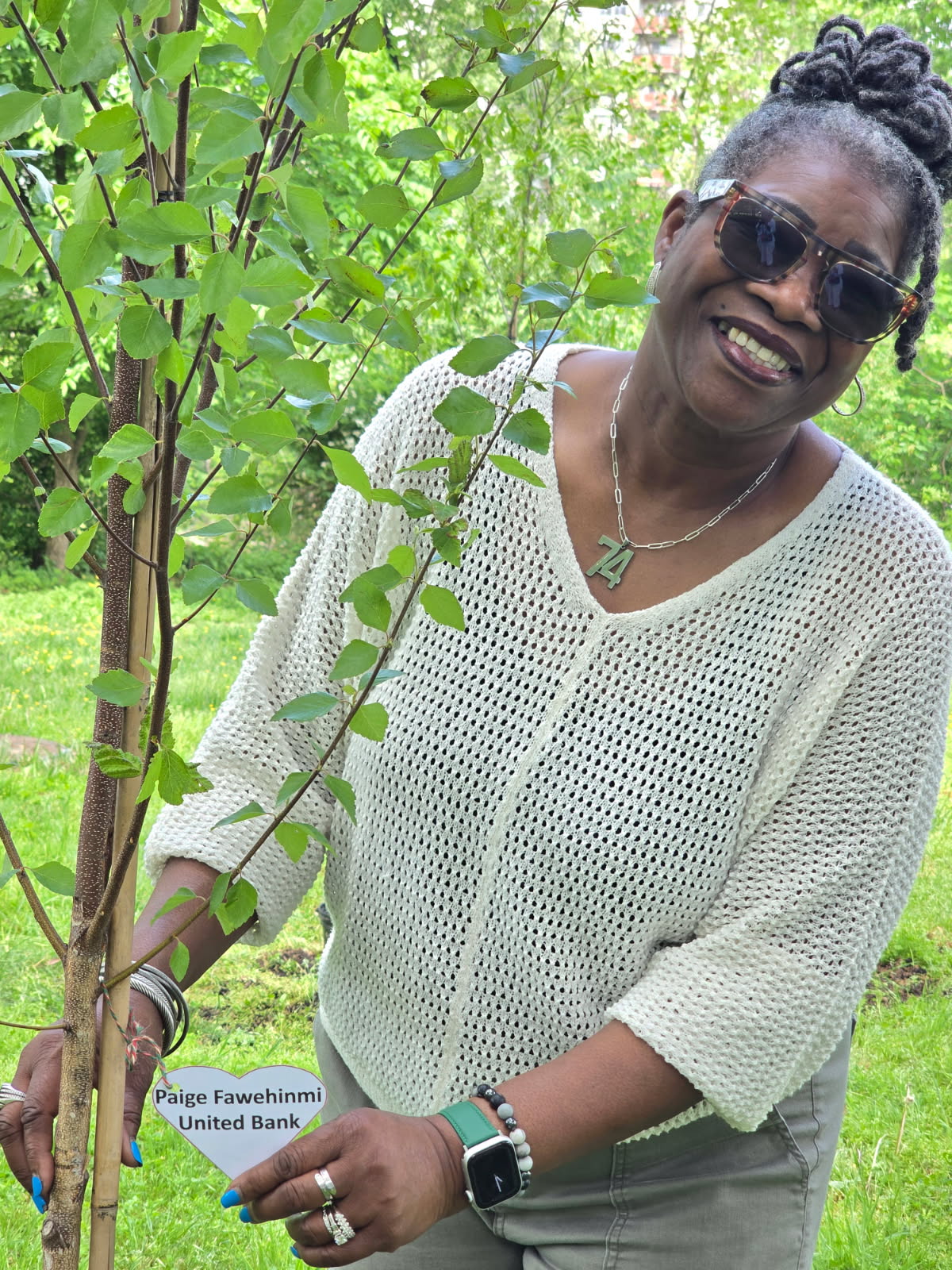 image000000 2 Paige Fawehinmi, United Bank, winner of the Volunteer Alexandria Business Philanthropist of the Year, stands with her tree